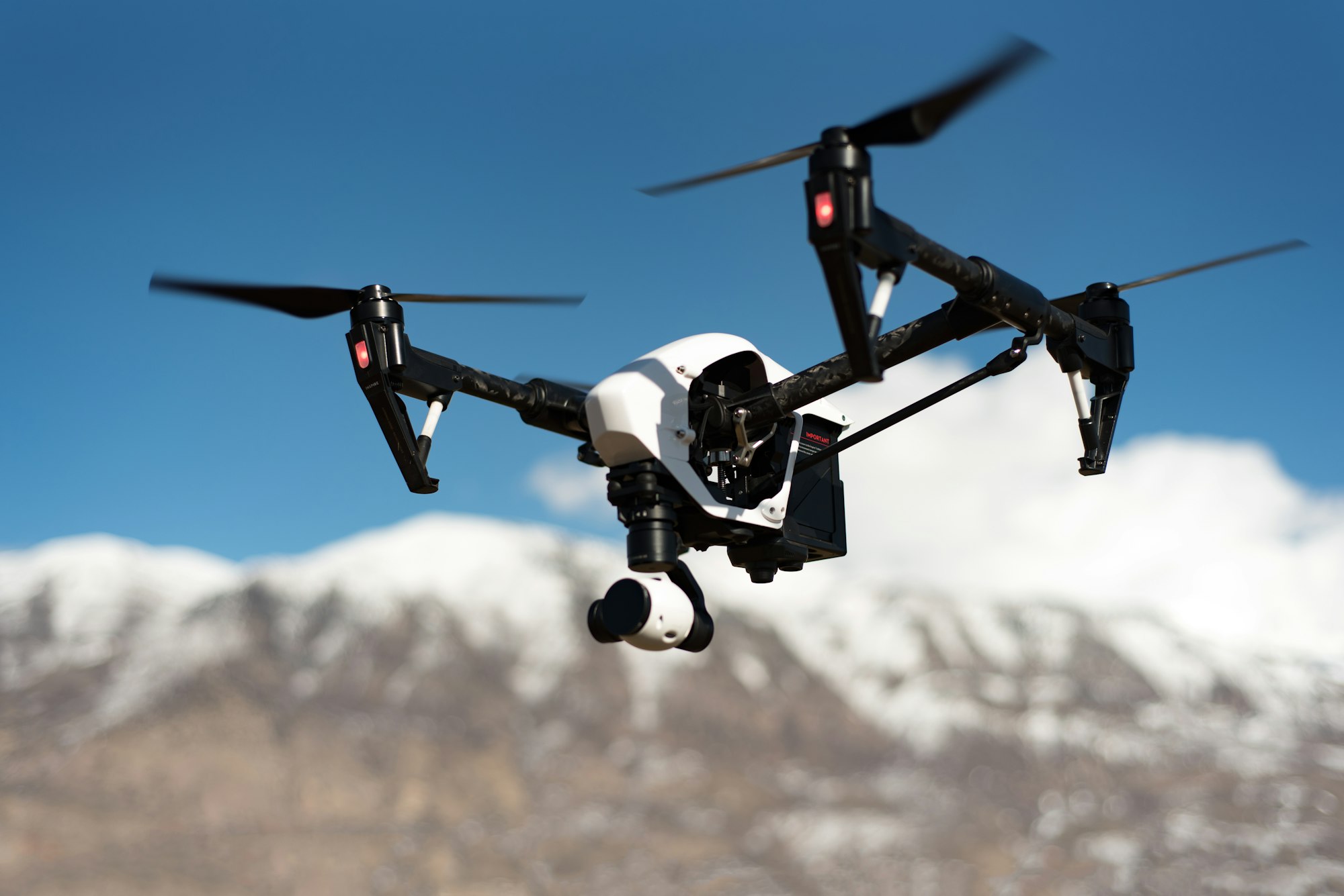 Quadcopter drone hovering above clouds
